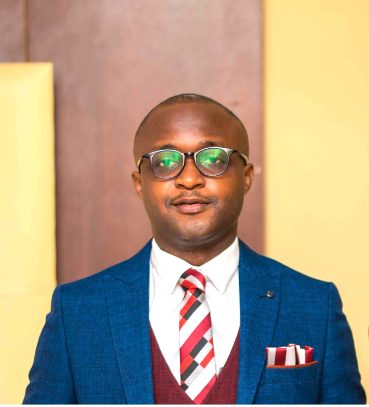 Gilead Ogbonna in a blue suit
