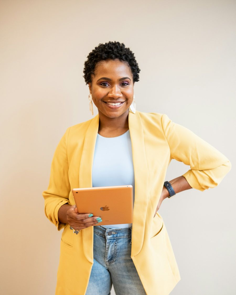 A founder holding her tablet, smiling