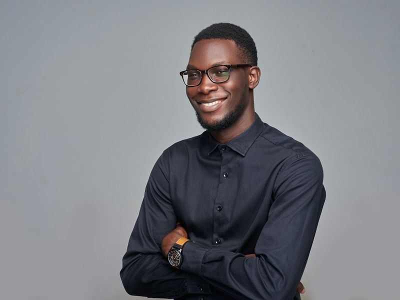 A confident founder with his arms folded, smiling