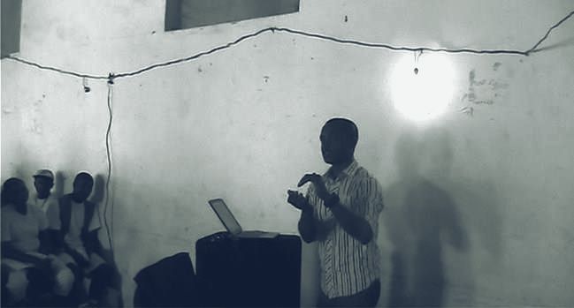 Gilead presenting to a group in a dimly lit room